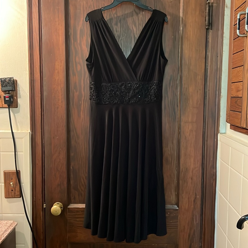 Black cocktail dress with sequined waistband.